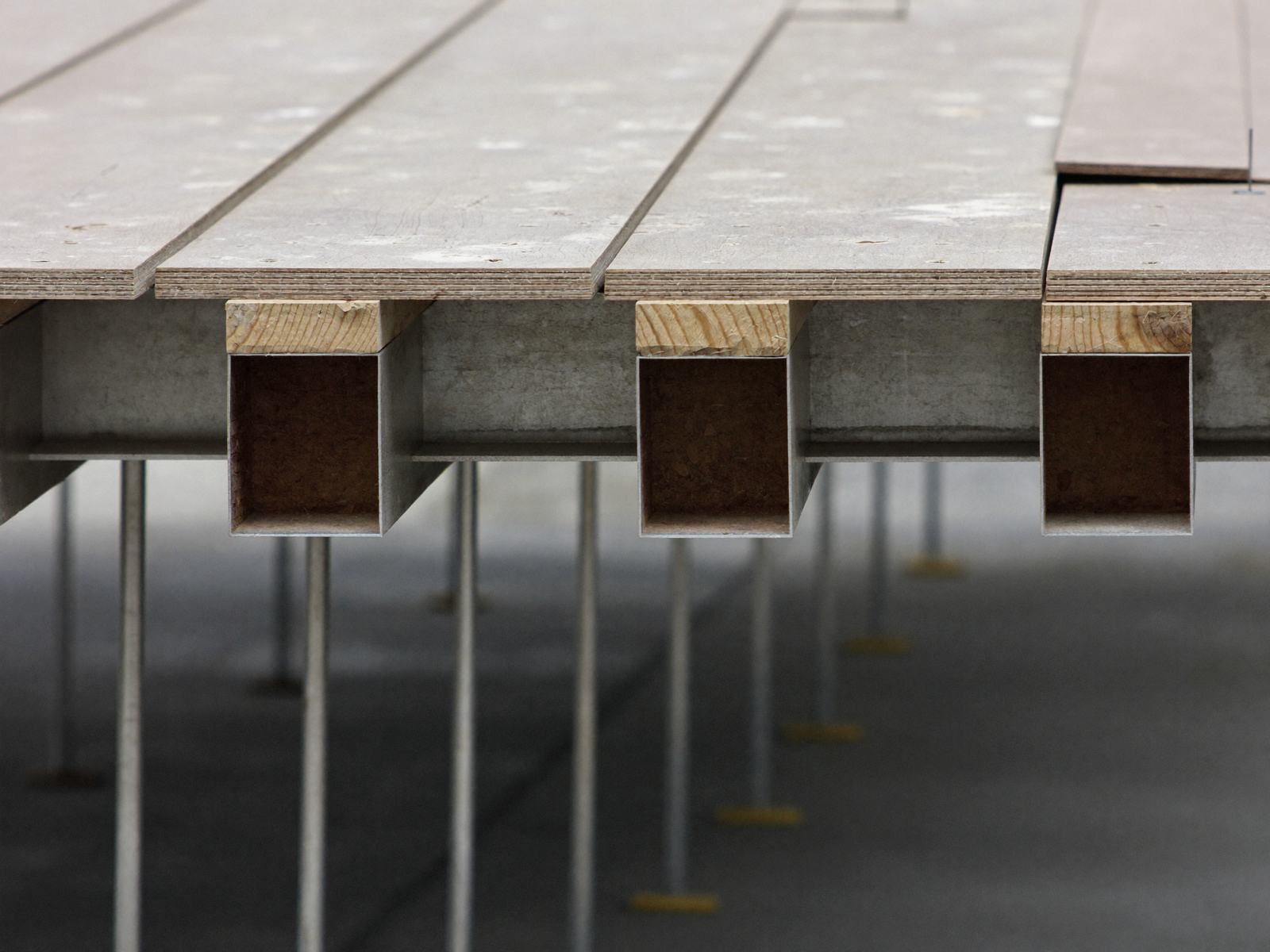 Plywood formwork deck on aluminium bearers with steel props in rows below